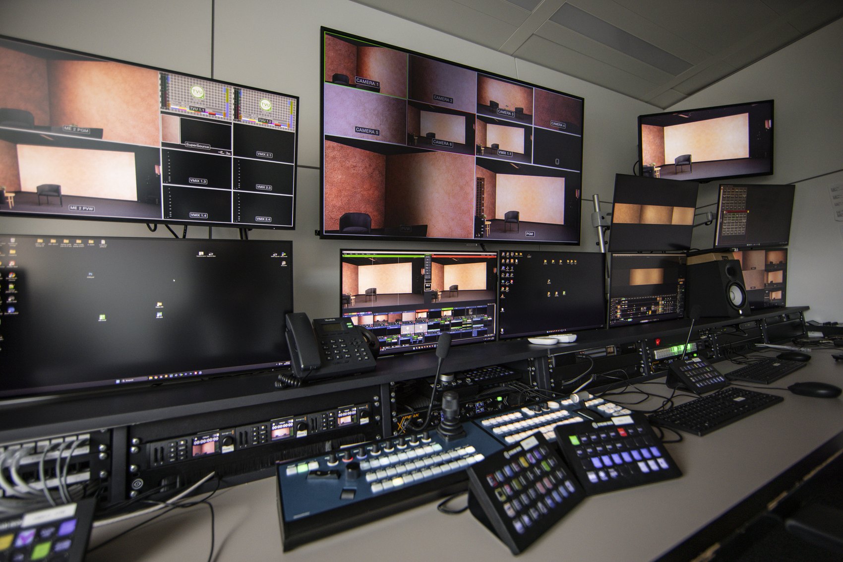 Sala de control amb la taula de realització i el mur de monitors de les sis càmeres